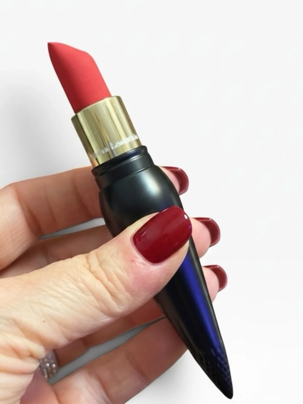 Christian Louboutin Black Spike-Detail Lipstick Holder with red lipstick